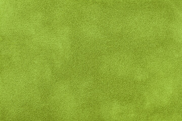 Dark green matte background of suede fabric, closeup. Velvet texture of textile