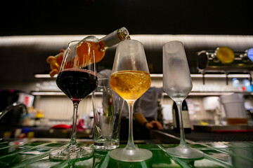 Pouring three glasses of wine from a wine bottle