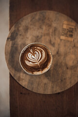  hot latte art coffee on wooden