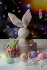 Easter decoration with toy bunny, painted eggs