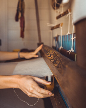 Woman's hand knitting on a machine