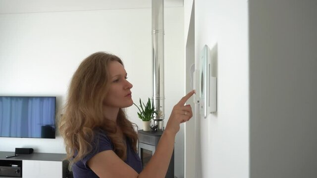 girl using controllers to control heating, ventilation and smart home functions
