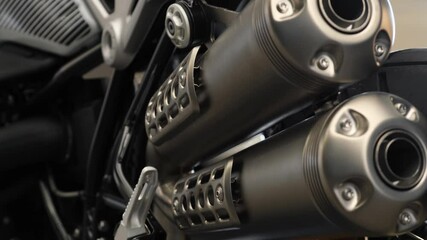 Twin exhaust pipe for a powerful modern sports bike. Motorcycle dealership selling new motorcycles. Closeup cinematic 4k footage.