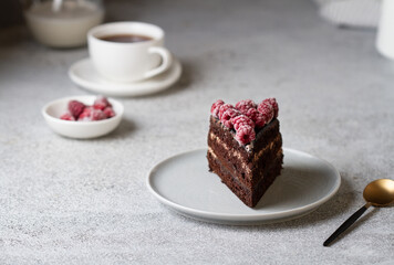 A piece of chocolate cake with raspberries on a plate