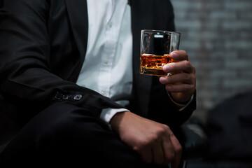Closeup businessmen holding a glass of whiskey
