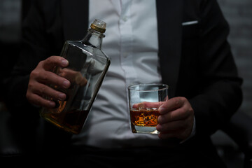 Closeup businessmen holding a glass of whiskey