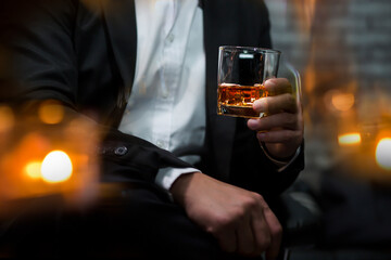 Closeup businessmen holding a glass of whiskey