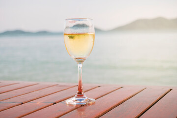 White Wine glass placed by the sea	