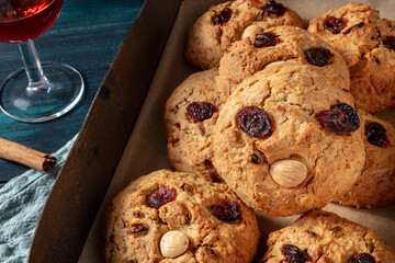 Homemade cookies in a baking tray, funny face biscuits with a drink