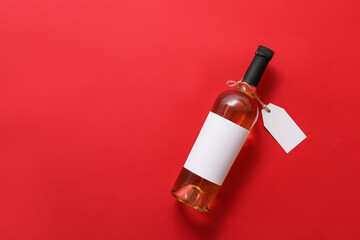 Bottle of wine with blank label on color background