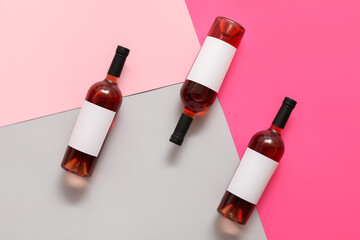 Bottles of wine with blank labels on color background