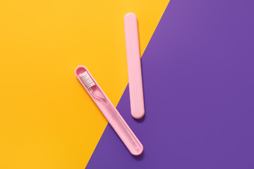 Toothbrush and case on color background