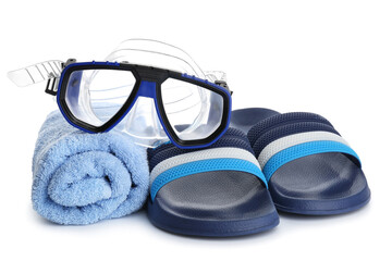 Male flip-flops with towel and snorkeling mask on white background