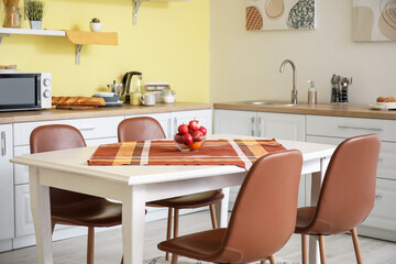 Interior of modern kitchen with dining table and chairs
