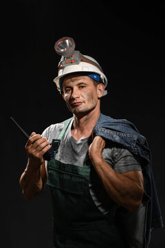 Miner man with two-way radio on dark background