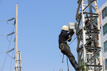 The technician is removing the electric bulb. Inside the substation