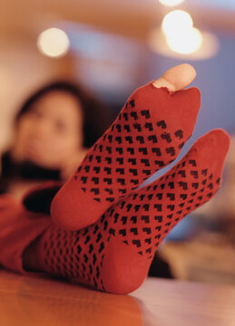 Young woman's toe poking out of a hole in her sock