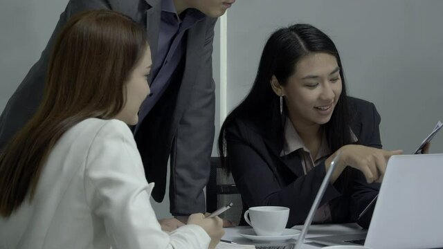 Business man explaining project with team. They using computer to working at office.