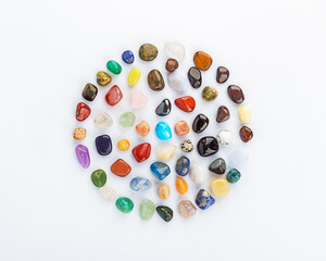 Collection of multicolored minerals and crystals in the form of a circle on a gray background. Flat lay. Harmony and balance. Chakra balancing, crystal ritual.