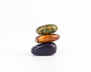 Tower of three mineral stones on a light gray background. Harmony and balance. Chakra balancing,...
