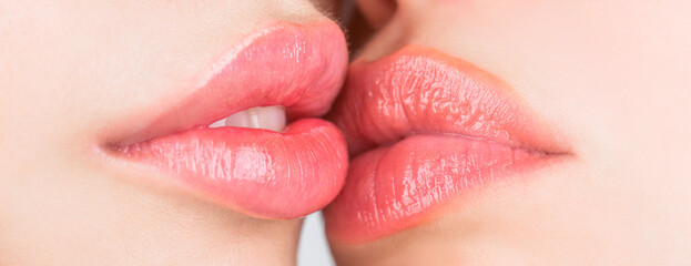 Two beautiful sexy lesbians in love. Lip care and beauty. Closeup of beautiful young woman healthy lips. Lesbian couple kiss lips. Passion and sensual touch. Closeup of women mouths kissing