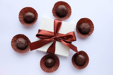 Beautiful gift boxes and chocolates isolated on a white background.