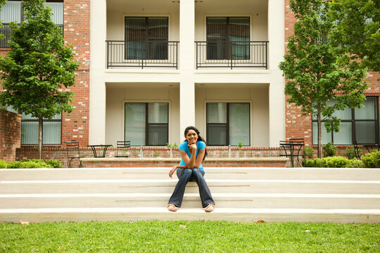 Mixed race woman sitting outdoors on stairs