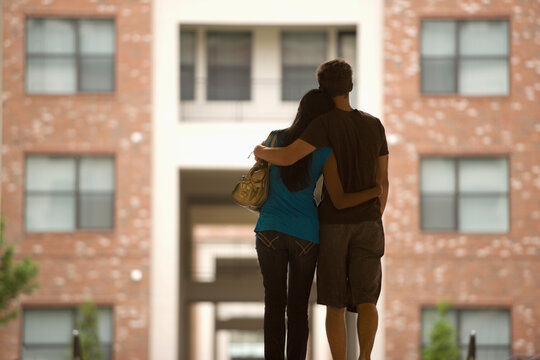 Rear view of couple hugging outdoors