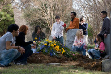 Multi-ethnic young adults at grave