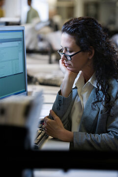 Caucasian businesswoman working on computer at desk