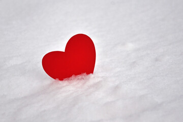 Fototapeta premium One red heart in the snow. A symbol of undivided love. Valentine's Day