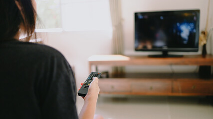 Watching smart  TV and using remote controller tv Hand holding television  audio remote control ...
