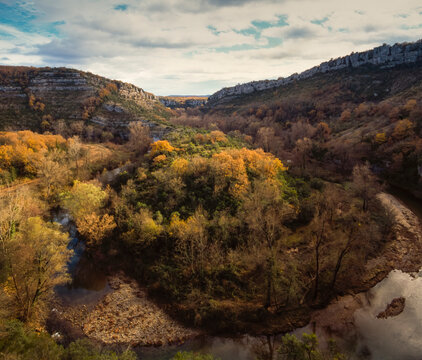 Plant covered landscape with river running through in the Ardech Gorge, France