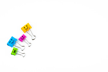 Colorful metal binders with smiles isolated on a white background, selective focus and soft focus