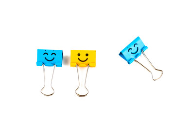 Colorful metal binders with smiles isolated on a white background, selective focus and soft focus
