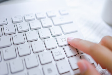 Hands of business woman Pressing enter button on computer keyboard