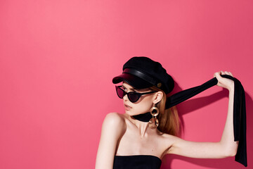Pretty elegant woman jewelry accessories dark glasses studio pink background