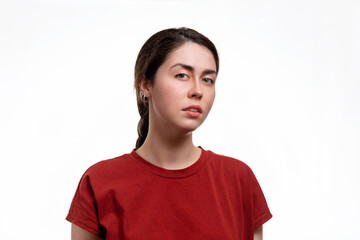 Portrait of a young woman with a disgruntled face. White background. the concept of human emotions