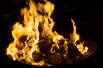 Burning flames of a campfire at night
