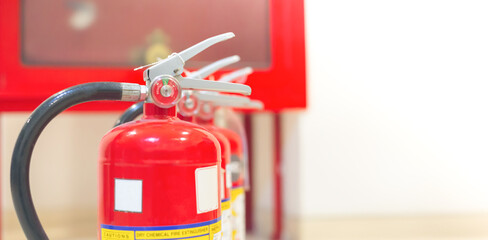 Red fire extinguishers available in fire emergencies,safety concept.