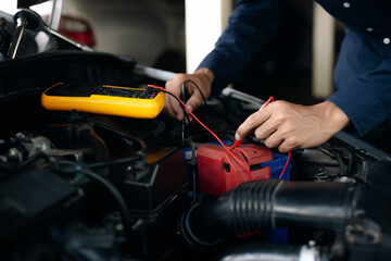 Car service, repair, maintenance concept. Auto mechanic working in garage.