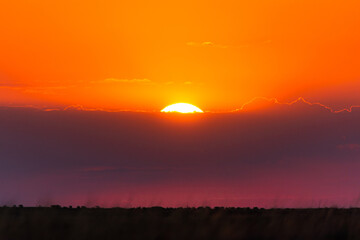 Red or orange sunset sky with stormy clouds