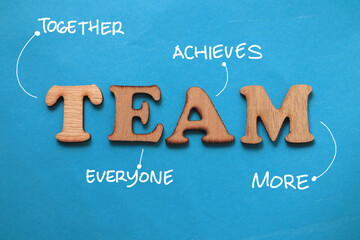 TEAM together everyone achieves more, text words typography written on paper against blue background, life and business motivational inspirational