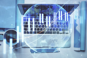 Double exposure of forex graph drawing over desktop background with computer. Concept of financial analysis. Top view.