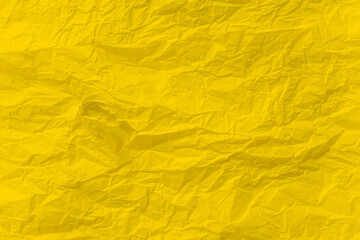 Yellow crumpled paper close up texture background