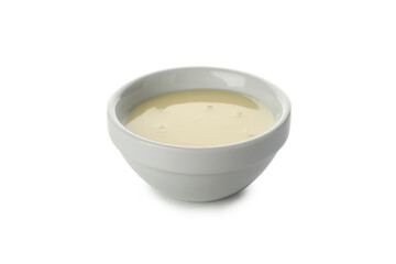 Bowl with condensed milk isolated on white background
