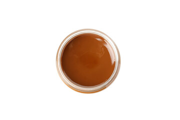 Glass jar with caramel condensed milk isolated on white background