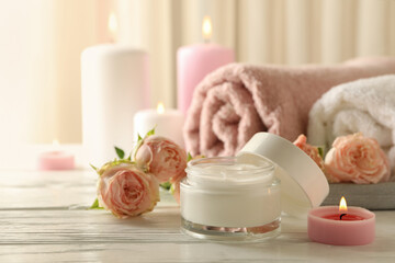 Obraz na płótnie Canvas Body care concept with scented candles on white wooden table