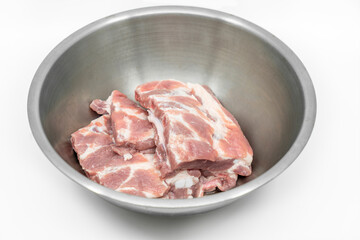 Soft spare ribs pork in stainless steel bowl, isolated image on white background, top view fresh soft spare ribs pork.
