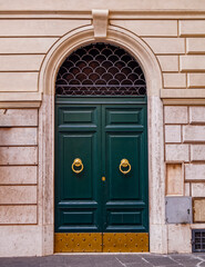 vintage residential building entrance arched green door, Rome Italy